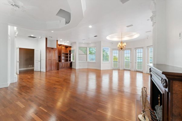 Chandelier, Empty room, Fireplace, Interior, Kitchen, Recessed Lighting, Wood Texture Flooring