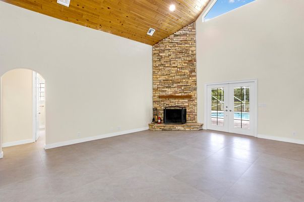 Empty room, Fireplace, Interior, Recessed Lighting, Stone Walls, Wooden Ceilings