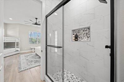 Bathroom, Glass Shower, Interior, Marble Walls, Recessed Lighting, Wood Texture Flooring