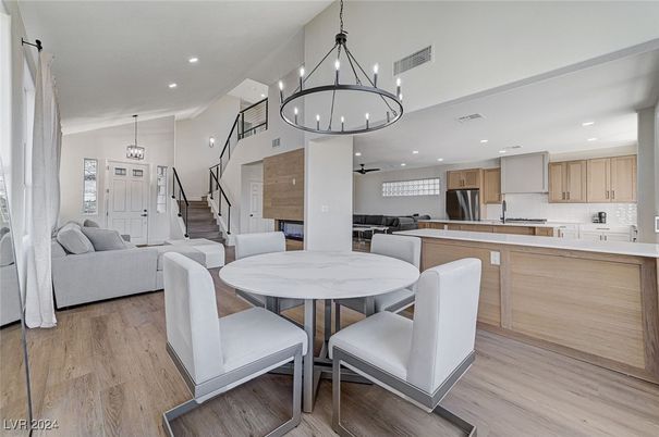 Chandelier, Dining room, Interior, Kitchen, Living room, Pendant Lights, Recessed Lighting, Stainless Steel Appliances, Wood Texture Flooring