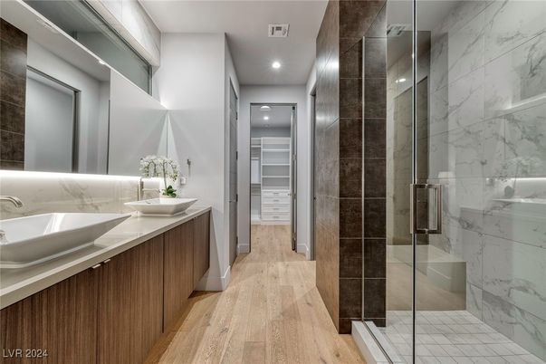 Bathroom, Dual Sink Vanities, Glass Shower, Interior, Marble Walls, Recessed Lighting, Walk-in Closets, Wood Texture Flooring