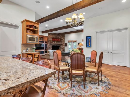 Chandelier, Dining room, Fireplace, Interior, Living room, Recessed Lighting, Stone Walls, Wooden Beams, Wood Texture Flooring