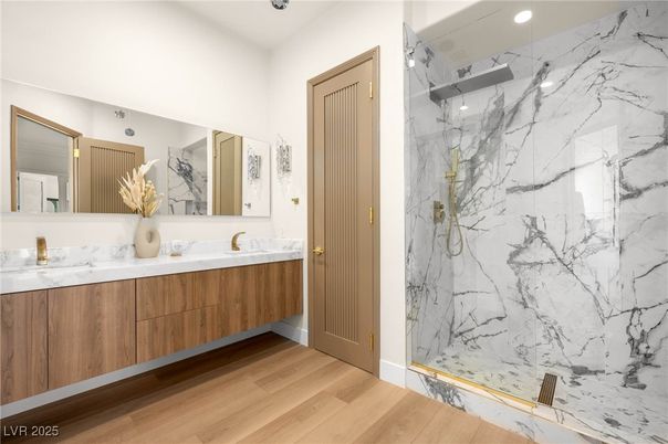 Bathroom, Dual Sink Vanities, Glass Shower, Interior, Marble Walls, Recessed Lighting, Wood Texture Flooring