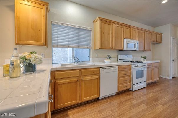 Interior, Kitchen, Recessed Lighting, Tile Countertops, Wood Texture Flooring