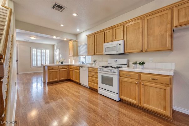Interior, Kitchen, Recessed Lighting, Tile Countertops, Wood Texture Flooring