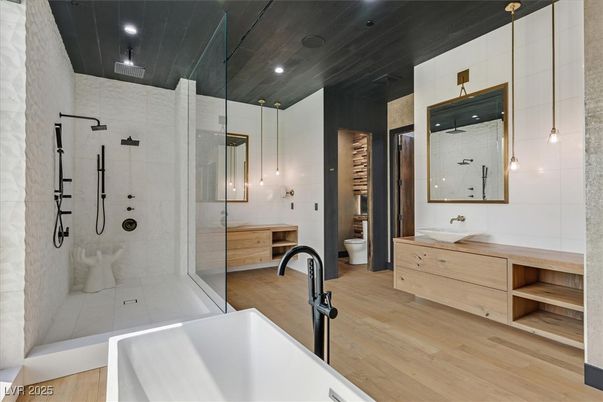 Bathroom, Dual Sink Vanities, Free Standing Baths, Glass Shower, Interior, Pendant Lights, Recessed Lighting, Wood Texture Flooring