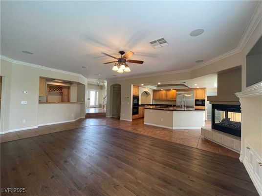 Empty room, Fireplace, Interior, Kitchen, Recessed Lighting, Stainless Steel Appliances, Wood Texture Flooring