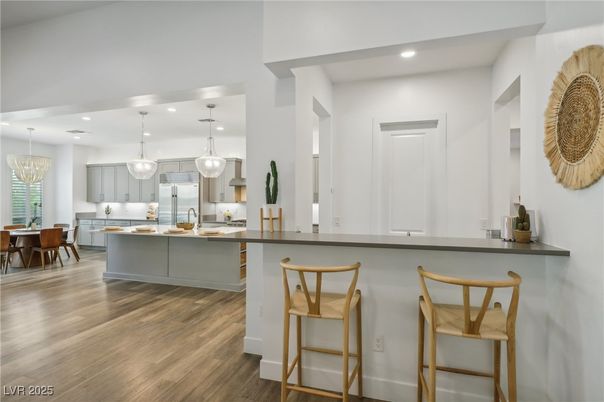 Chandelier, Dining room, Interior, Kitchen, Pendant Lights, Recessed Lighting, Stainless Steel Appliances, Wood Texture Flooring