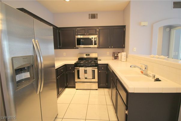 Interior, Kitchen, Recessed Lighting, Stainless Steel Appliances, Tile Countertops