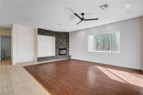 Empty room, Fireplace, Interior, Recessed Lighting, Stone Walls, Wood Texture Flooring