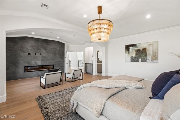 Bedroom, Chandelier, Fireplace, Interior, Recessed Lighting, Wood Texture Flooring