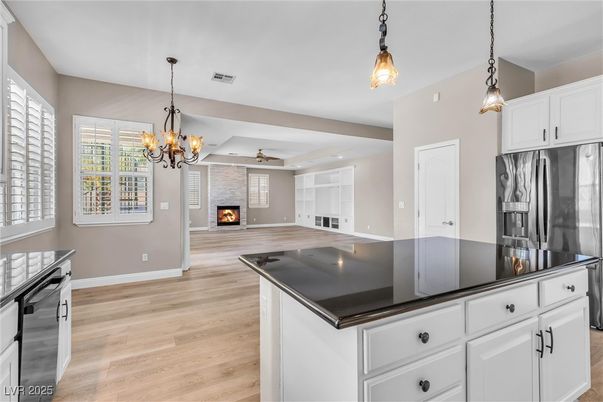 Chandelier, Empty room, Fireplace, Interior, Kitchen, Pendant Lights, Recessed Lighting, Wood Texture Flooring