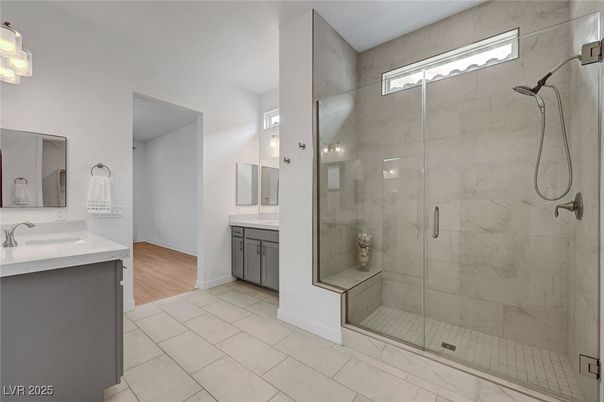 Bathroom, Dual Sink Vanities, Glass Shower, Interior, Marble Walls, Wood Texture Flooring