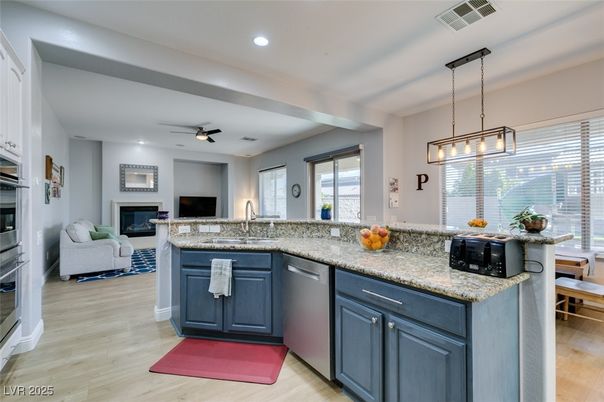 Fireplace, Interior, Kitchen, Living room, Pendant Lights, Recessed Lighting, Stainless Steel Appliances, Wood Texture Flooring