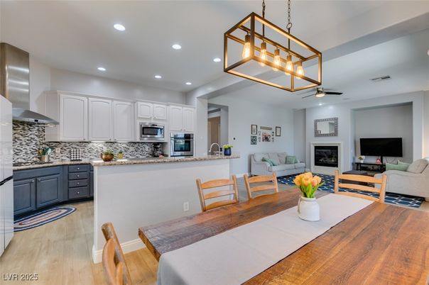 Dining room, Fireplace, Interior, Kitchen, Living room, Pendant Lights, Recessed Lighting, Stainless Steel Appliances, Wood Texture Flooring