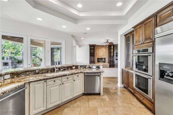 Fireplace, Interior, Kitchen, Recessed Lighting, Stainless Steel Appliances, Stone Walls