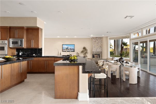 Dining room, Fireplace, Interior, Kitchen, Recessed Lighting, Stainless Steel Appliances, Wood Texture Flooring