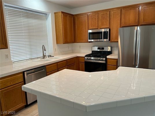 Interior, Kitchen, Stainless Steel Appliances, Tile Countertops, Wood Texture Flooring