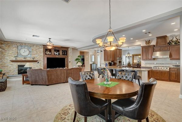 Chandelier, Dining room, Fireplace, Interior, Kitchen, Living room, Pendant Lights, Recessed Lighting, Stainless Steel Appliances, Stone Walls