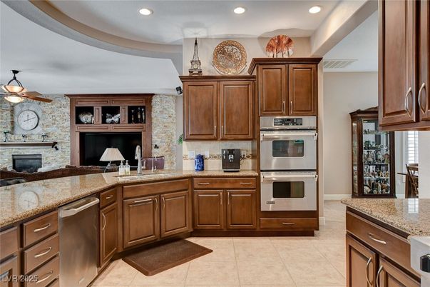 Fireplace, Interior, Kitchen, Recessed Lighting, Stainless Steel Appliances, Stone Walls