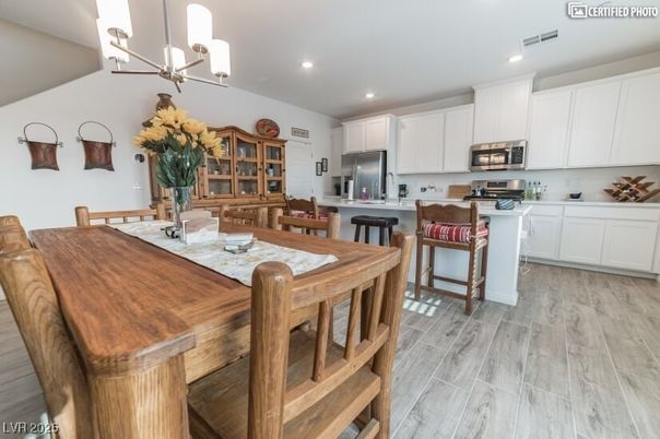 Chandelier, Dining room, Interior, Kitchen, Recessed Lighting, Stainless Steel Appliances, Wood Texture Flooring
