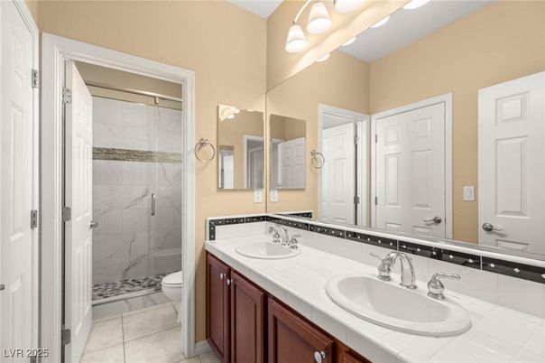 Bathroom, Dual Sink Vanities, Glass Shower, Interior, Marble Walls, Tile Countertops