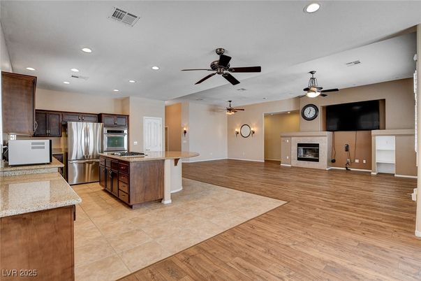 Fireplace, Interior, Kitchen, Recessed Lighting, Stainless Steel Appliances, Wood Texture Flooring