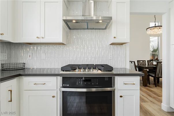 Chandelier, Dining room, Interior, Kitchen, Pendant Lights, Stainless Steel Appliances, Wood Texture Flooring