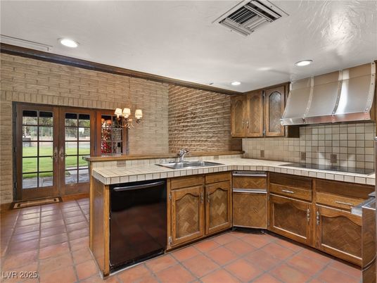 Interior, Kitchen, Recessed Lighting, Stainless Steel Appliances, Stone Walls, Tile Countertops