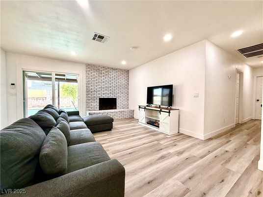 Fireplace, Interior, Living room, Recessed Lighting, Stone Walls, Wood Texture Flooring