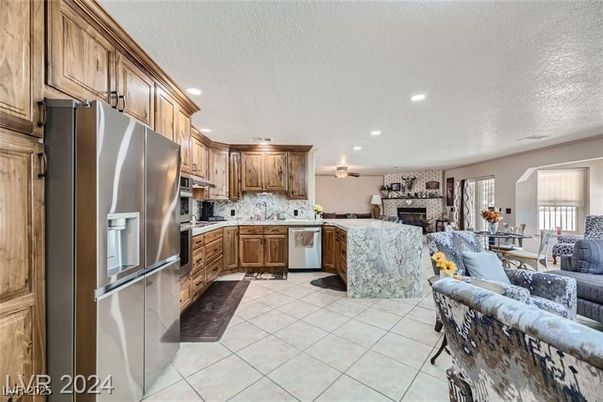 Fireplace, Interior, Kitchen, Living room, Recessed Lighting, Stainless Steel Appliances, Stone Walls