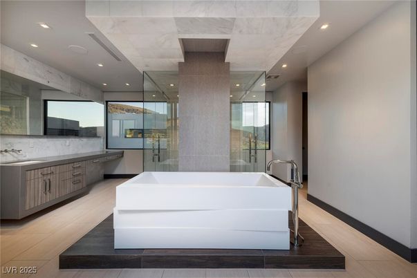 Bathroom, Free Standing Baths, Glass Shower, Interior, Marble Walls, Recessed Lighting, Wood Texture Flooring