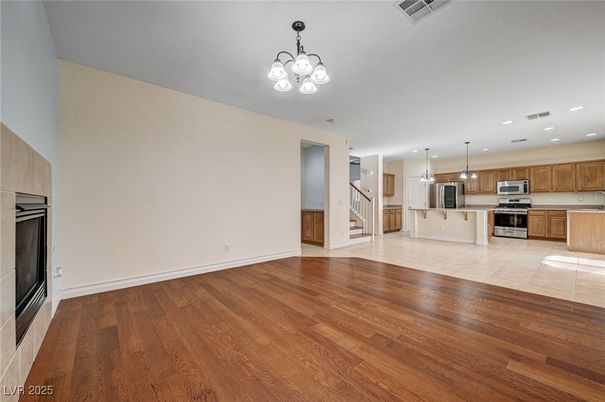 Empty room, Interior, Kitchen, Pendant Lights, Recessed Lighting, Stainless Steel Appliances, Wood Texture Flooring