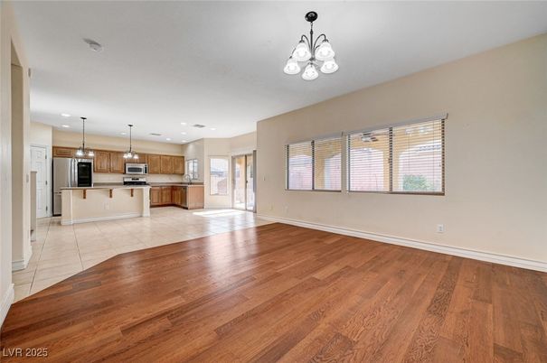 Chandelier, Empty room, Interior, Kitchen, Pendant Lights, Recessed Lighting, Stainless Steel Appliances, Wood Texture Flooring