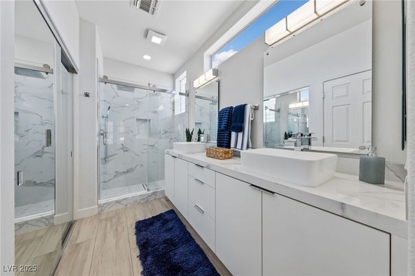 Bathroom, Dual Sink Vanities, Glass Shower, Interior, Marble, Marble Walls, Recessed Lighting, Wood Texture Flooring