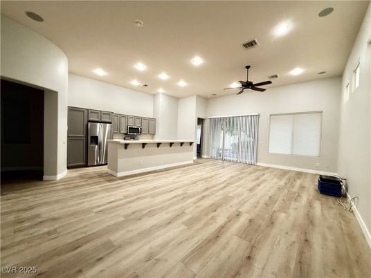 Empty room, Interior, Kitchen, Recessed Lighting, Stainless Steel Appliances, Wood Texture Flooring