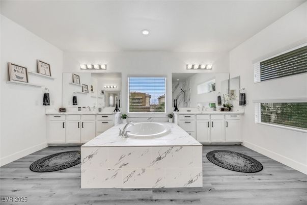 Bathroom, Dual Sink Vanities, Interior, Marble Walls, Recessed Lighting, Wood Texture Flooring
