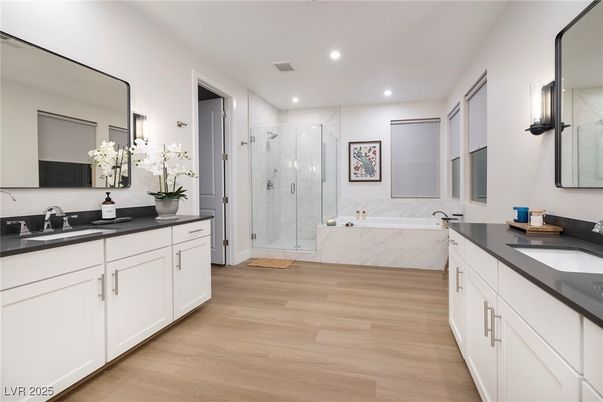 Bathroom, Dual Sink Vanities, Glass Shower, Interior, Marble Walls, Recessed Lighting, Wood Texture Flooring