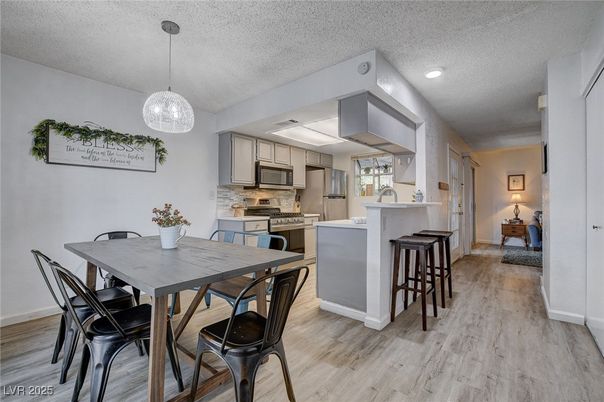Dining room, Interior, Kitchen, Pendant Lights, Recessed Lighting, Stainless Steel Appliances, Wood Texture Flooring