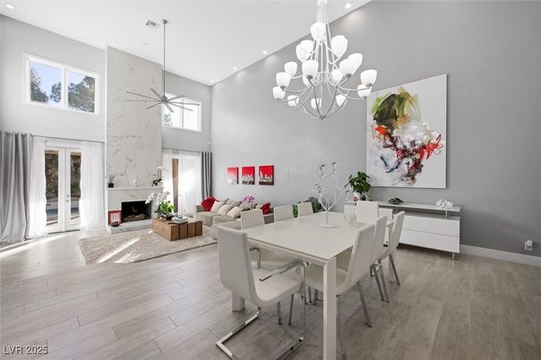 Chandelier, Dining room, Fireplace, Interior, Living room, Pendant Lights, Recessed Lighting, Wood Texture Flooring