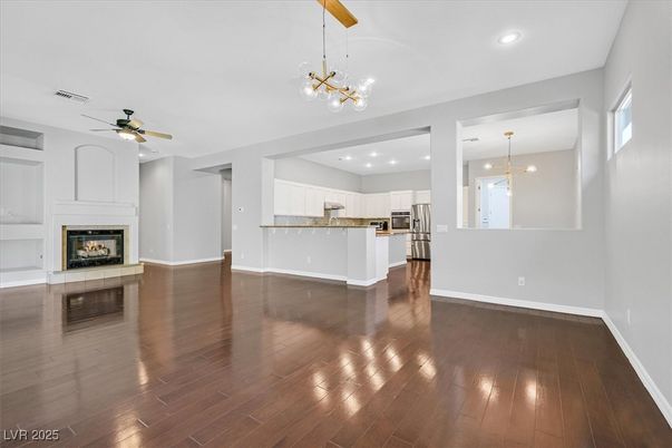 Empty room, Fireplace, Interior, Kitchen, Pendant Lights, Recessed Lighting, Wood Texture Flooring