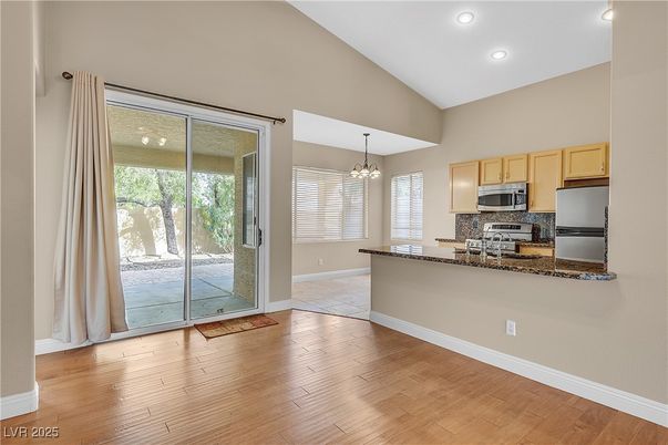 Chandelier, Empty room, Interior, Kitchen, Recessed Lighting, Stainless Steel Appliances, Wood Texture Flooring