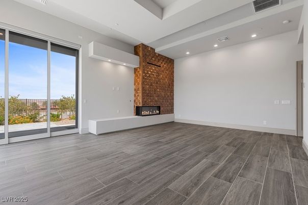 Empty room, Fireplace, Interior, Recessed Lighting, Stone Walls, Wood Texture Flooring
