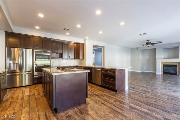 Fireplace, Interior, Kitchen, Recessed Lighting, Stainless Steel Appliances, Wood Texture Flooring