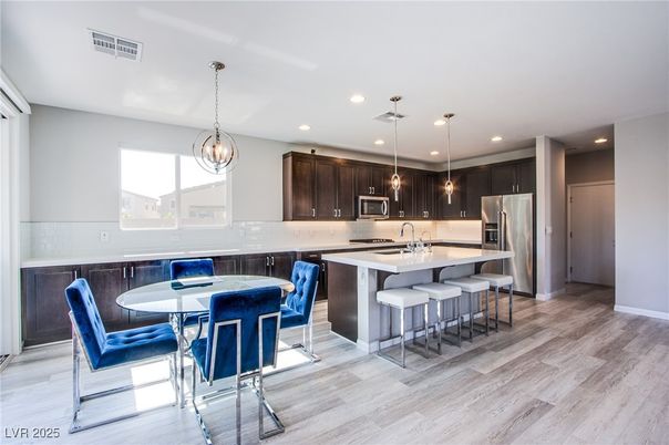 Chandelier, Dining room, Interior, Kitchen, Pendant Lights, Recessed Lighting, Stainless Steel Appliances, Wood Texture Flooring