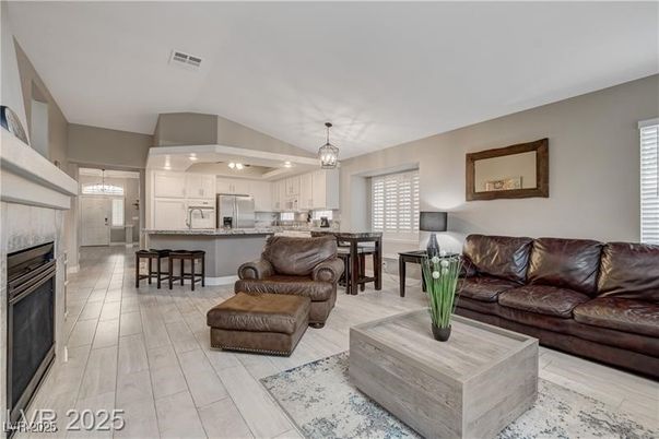 Chandelier, Dining room, Fireplace, Interior, Kitchen, Living room, Pendant Lights, Stainless Steel Appliances, Wood Texture Flooring