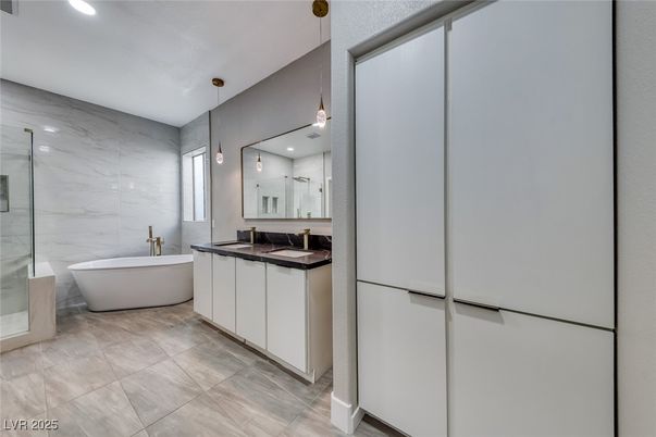 Bathroom, Dual Sink Vanities, Free Standing Baths, Glass Shower, Interior, Marble Walls, Pendant Lights, Recessed Lighting
