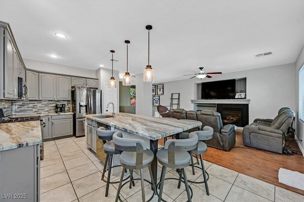 Fireplace, Interior, Kitchen, Living room, Pendant Lights, Recessed Lighting, Stainless Steel Appliances, Wood Texture Flooring
