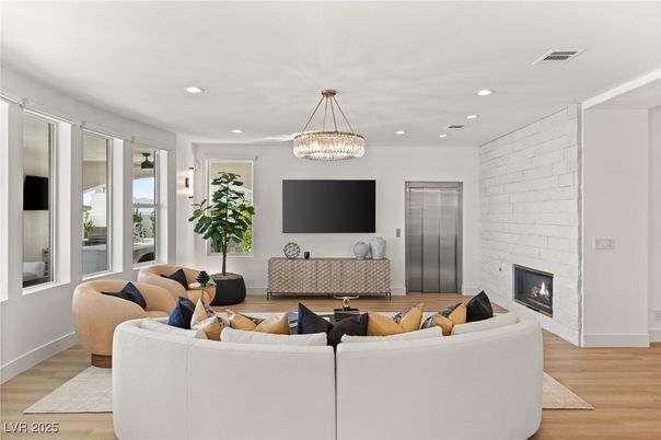 Chandelier, Fireplace, Interior, Living room, Recessed Lighting, Stone Walls, Wood Texture Flooring