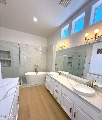 Bathroom, Dual Sink Vanities, Free Standing Baths, Glass Shower, Interior, Marble Walls, Recessed Lighting, Wood Texture Flooring